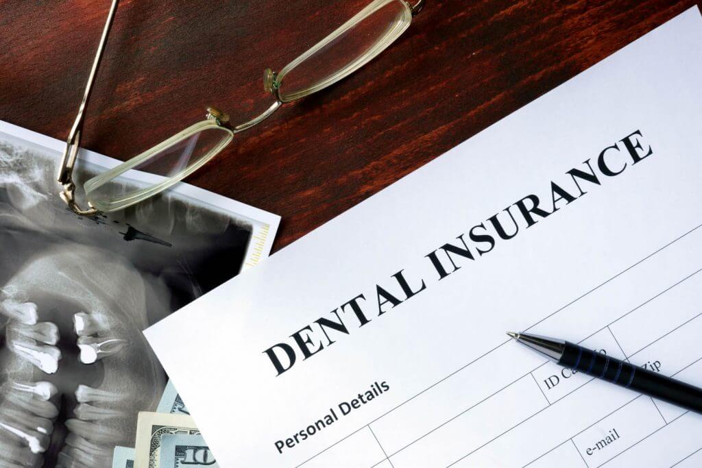 Dental insurance form on the wooden table.