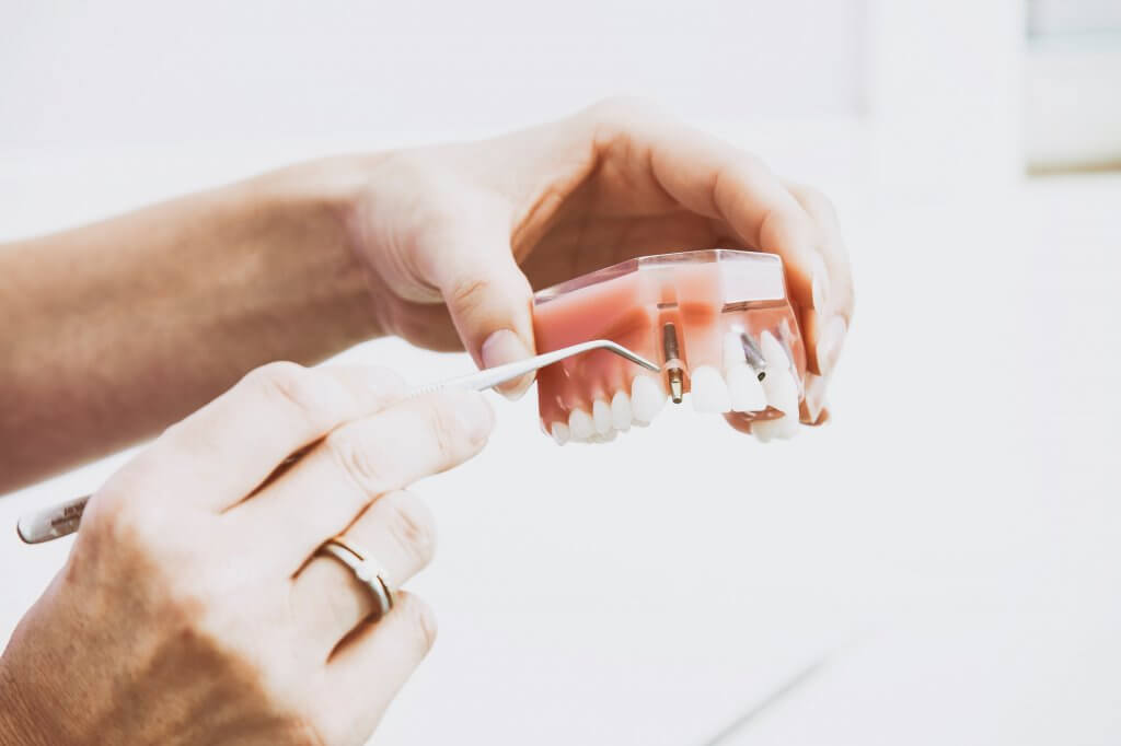 Dentist holding a tray of teeth