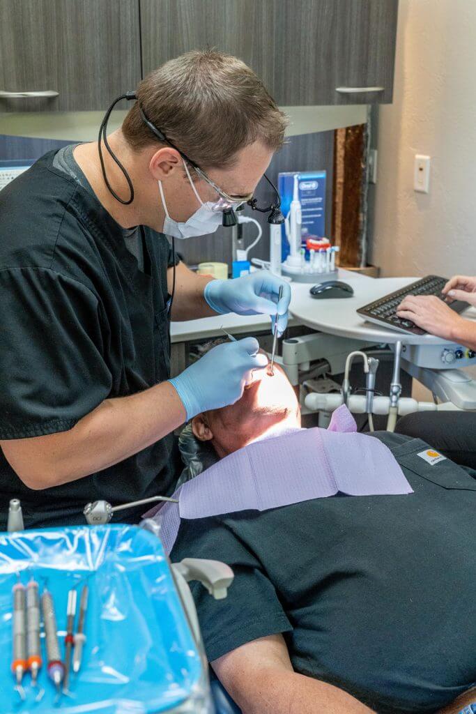 Dentist performing a prophylaxis treatment on a patient